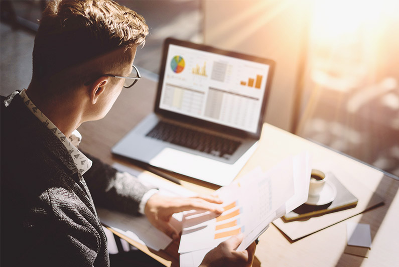 An Asian couple hugs outside their newly purchased home.
