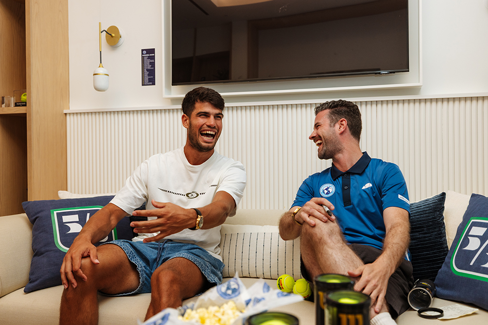 image of two people sitting on a couch laughing
