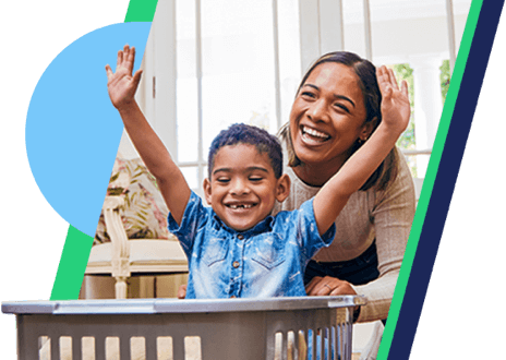 a smiling woman stands behind a smiling child with his arms up