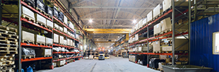 Interior view of a large material handling warehouse facility with stacked shelving.­
